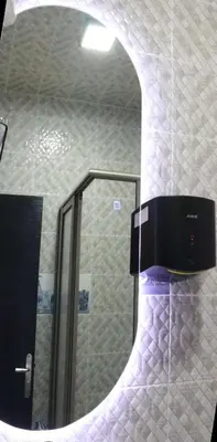 a mirror in a bathroom with a sink at Jolie appartement à Ifrane calme et spacieux in Ifrane