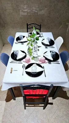 a table with a white table cloth on top of it at Maison Chafik in Fès