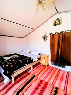 a bedroom with a bed in a room at The dune camp in Mhamid