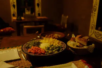 a table with two plates of food on a table at The dune camp in Mhamid