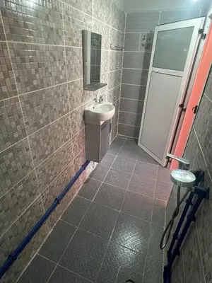 a bathroom with a toilet and a sink and a mirror at Taghadoute Hotel in Tazenakht