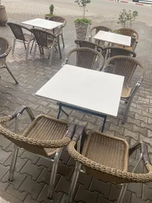 a group of tables and chairs in a patio at Taghadoute Hotel in Tazenakht