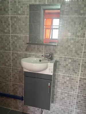 a bathroom with a sink and a mirror at Taghadoute Hotel in Tazenakht