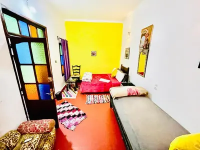 a room with a couch and a bed in it at Blue Star Hostel in Fès