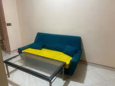 a blue and yellow couch in a room at Meknes in Meknès