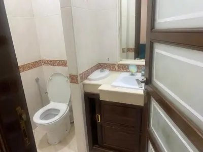 a small bathroom with a toilet and a sink at Meknes in Meknès