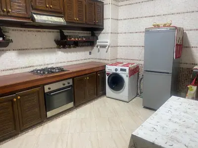 a kitchen with a refrigerator and a washing machine at Meknes in Meknès