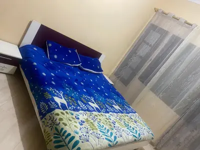 a blue bed in a room next to a window at Meknes in Meknès