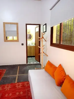 a living room with a white couch and a window at فيلا رياض عمران in Douar Blidene