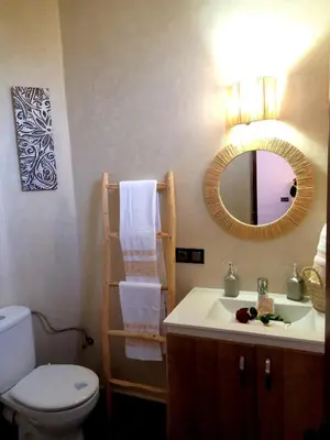 a bathroom with a sink and a toilet and a mirror at فيلا رياض عمران in Douar Blidene