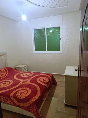 a bedroom with a bed and a window in it at Appartement tradimoderne in Mrhila