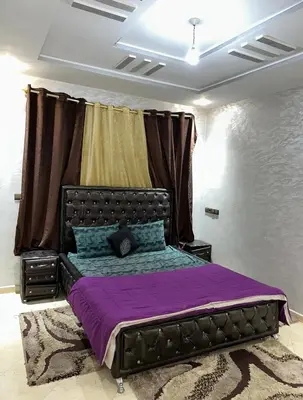 a bedroom with a large bed with purple sheets at بدون اسم in Fès