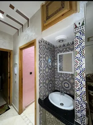 a bathroom with a sink and a mirror at بدون اسم in Fès