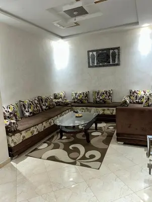 a living room with a couch and a table at بدون اسم in Fès