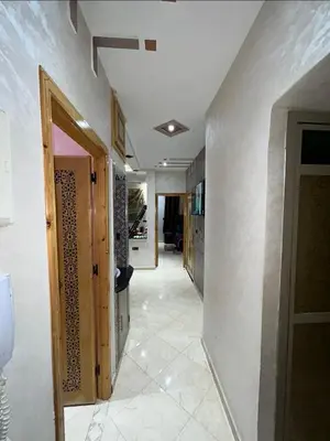 a hallway of a home with white walls and tile floors at بدون اسم in Fès