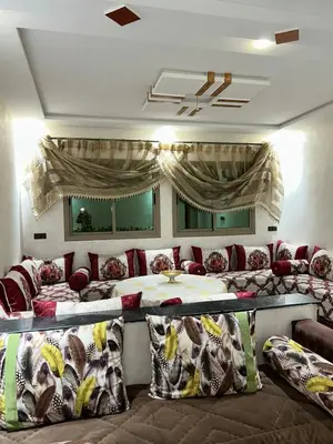 a bedroom with two beds and pillows in a room at بدون اسم in Fès
