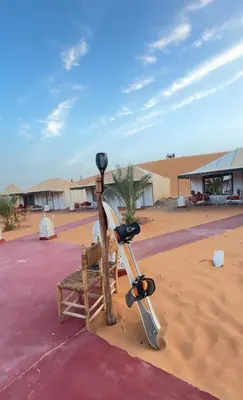 a bench and a parking meter in the desert at eclipse du desert in Merzouga