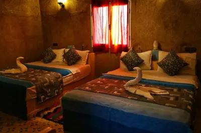 a bedroom with two beds with animal skulls on them at Kasbah Du Berger & Piscine in Merzouga