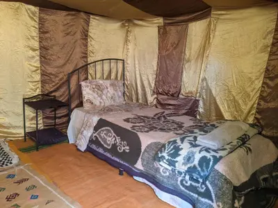 a bedroom with a bed in a tent at Camp azmamar in Mhamid