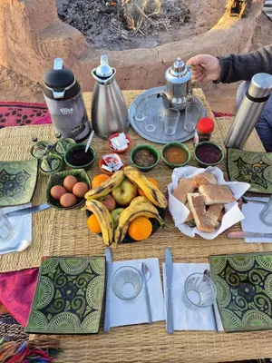 a table with food on top of it at Camp azmamar in Mhamid