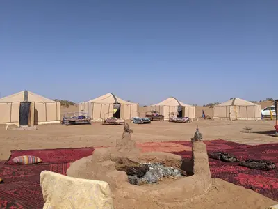 a sand castle in front of some tents at Camp azmamar in Mhamid