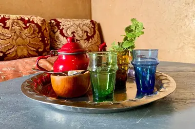 a tray with three different colored glasses on a table at Nomadic Birdway in Imiter