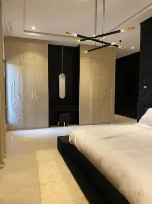 a bedroom with a bed and a ceiling fan at Villa M avec Piscine Chauffée in Marrakech