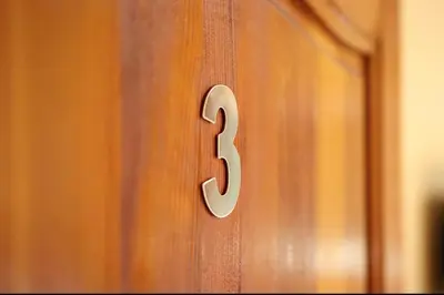 a wooden door with a number three on it at Fes apartment in Fès