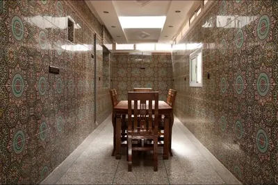 a table and chairs in a room with tiles at Fes apartment in Fès