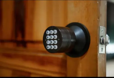 a black door knob on a wooden door at Fes apartment in Fès