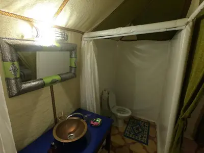 a small bathroom with a sink and a toilet at Merzouga Activities Camp in Merzouga