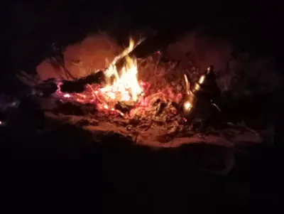 a bonfire burning in the dark at night at Canadien camp merzouga in Merzouga