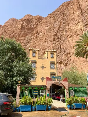 a hotel with a mountain in the background at Hotel De La Vallée in Aït Baha