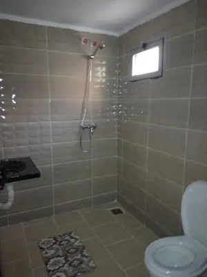 a bathroom with a shower and a toilet at Hotel De La Vallée in Aït Baha