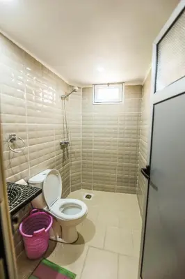 a bathroom with a toilet and a sink at Hotel De La Vallée in Aït Baha
