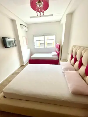 a small room with two beds and a window at Bel appartement meublé avec Wifi fibre optique in Fès