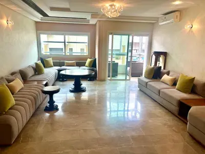 a large living room with couches and a table at Bel appartement meublé avec Wifi fibre optique in Fès