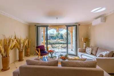 a living room with a couch and a table with chairs at Villa Naël Marrakech in Marrakech