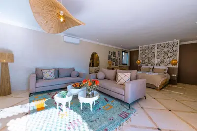 a living room with a couch and a table at Villa Naël Marrakech in Marrakech