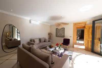 a living room with a couch and a table at Villa Naël Marrakech in Marrakech