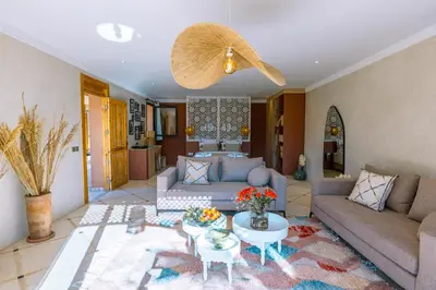 a living room with a couch and a table at Villa Naël Marrakech in Marrakech