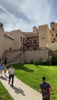 a group of people flying a kite in front of a building at Dar Lalla Yedouna Chez Charifa in Fès