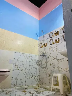 a bathroom with a shower and a stool at Dar Lalla Yedouna Chez Charifa in Fès