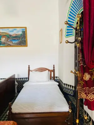 a bedroom with a bed in a room at Dar Lalla Yedouna Chez Charifa in Fès