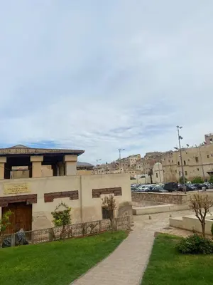 a building in a city with a grass yard at Dar Lalla Yedouna Chez Charifa in Fès