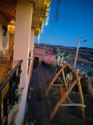a balcony of a house with a view of a river at CHÂTELET Ouarzazate in Tabount