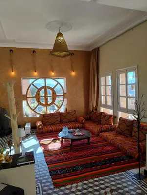 a living room with couches and a table and a window at CHÂTELET Ouarzazate in Tabount