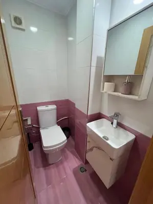 a bathroom with a white toilet and a sink at Appartement luxueux à Fès in Douar Oulad Mhammed