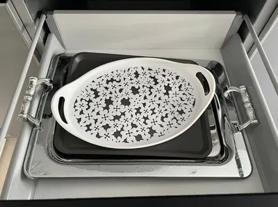 a white bowl is sitting on a tray in a drawer at Appartement luxueux à Fès in Douar Oulad Mhammed