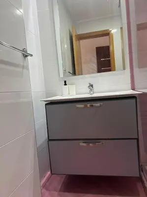 a bathroom with a sink and a mirror at Appartement luxueux à Fès in Douar Oulad Mhammed